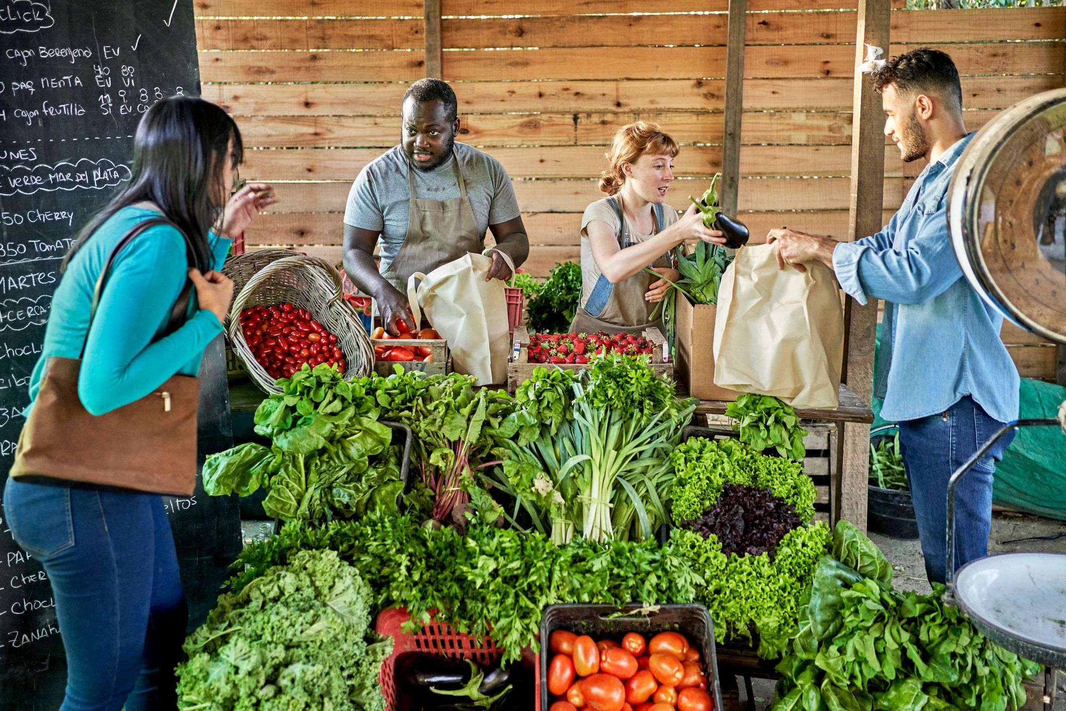 Customers buying produce at a farm stand