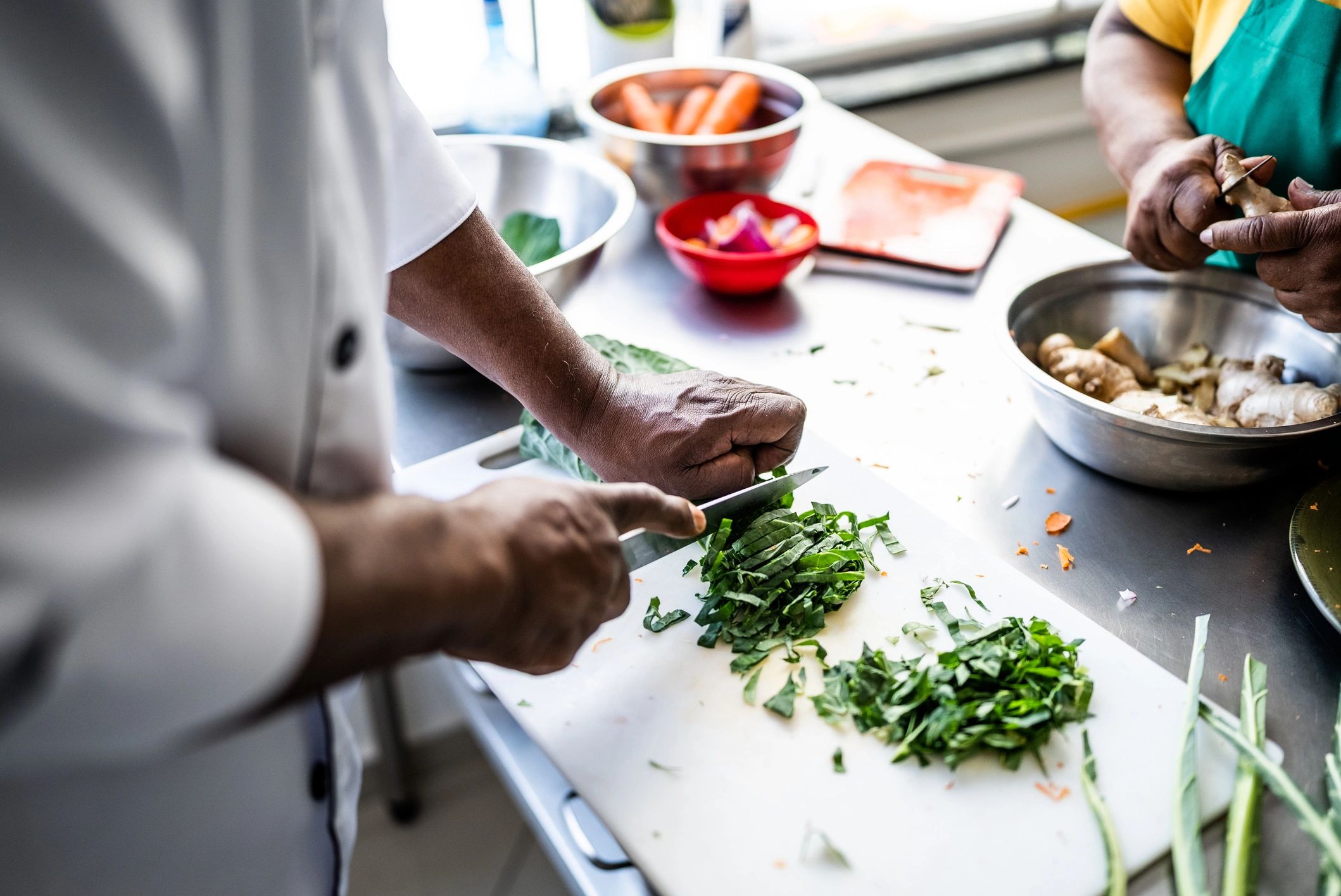 Hands chopping fresh vegetables for a meal