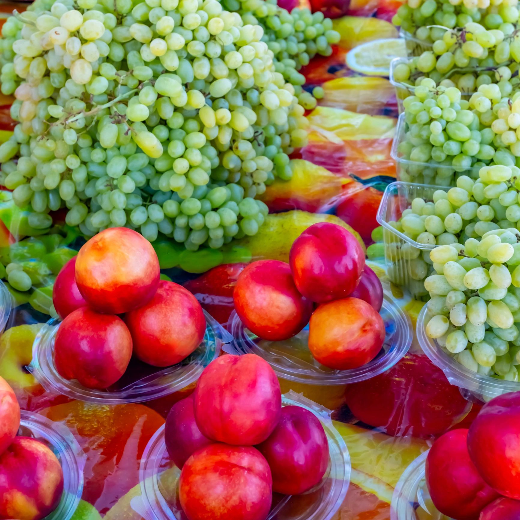 Fresh fruit including peaches, apples, and grapes