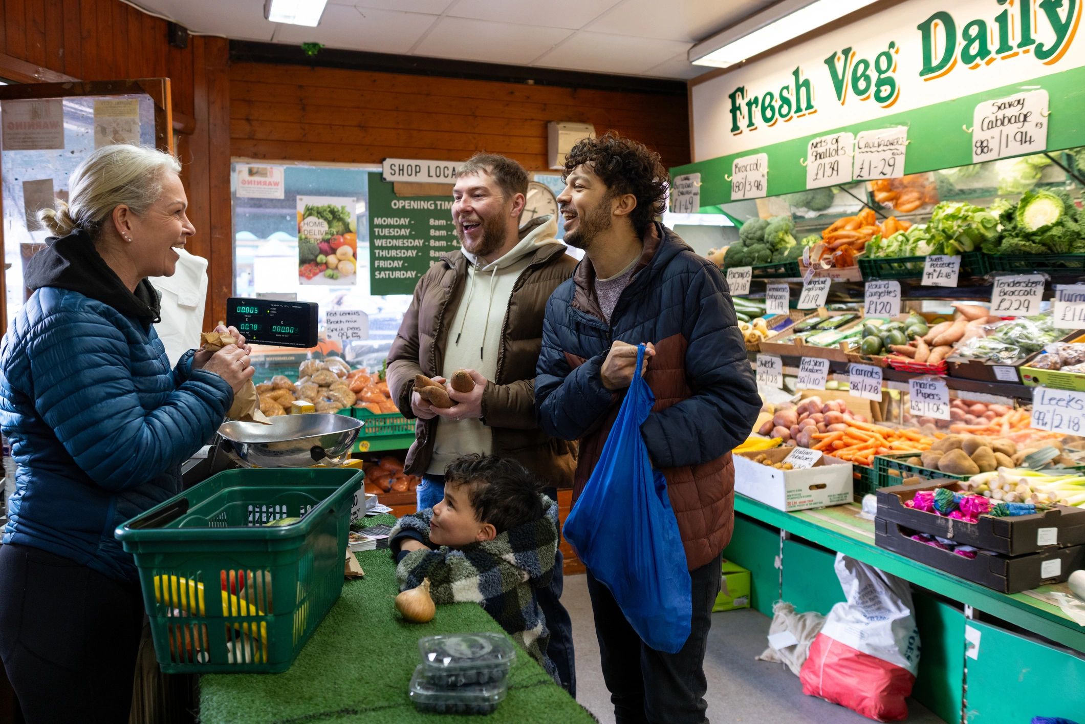Family shopping for fresh produce at a local greengrocer